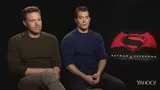 A dejected Ben Affleck seated beside Henry Cavill during the Batman v Superman interview