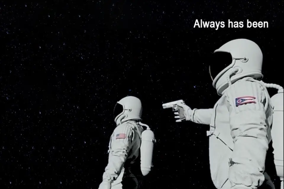 Two astronauts, one pointing a gun, 'always has been' format