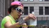 Man in a neon green shirt, pink backwards cap and sunglasses raising a white bottle, subtitled "cheers i'll drink to that bro"