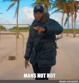 Man in a heavy black fur-hooded puffer jacket and cap on a palm-lined beach, captioned "MANS NOT HOT"