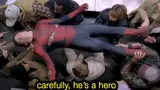 Spider-Man in a red and blue suit lying flat, held overhead by a crowd of train passengers, subtitled "carefully, he's a hero"