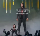 Long-haired man in a dark suit on a stage beside a shrunken copy of himself, labelled "Me, answering the door" and "My dog"