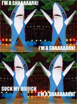 Mirrored panels of blue shark mascots dancing onstage under captions "I'M A SHAAAAARK!" and a crude punchline