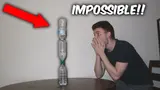 Water bottles balanced upright on a table with a red arrow and a shocked onlooker