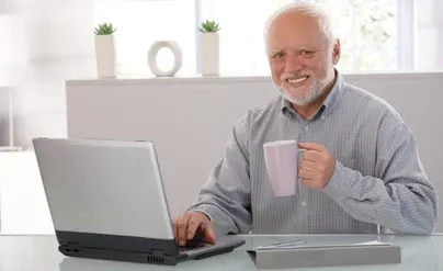 An older man with a strained, pained smile