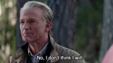 Film still of an elderly man with slicked-back grey hair outdoors, subtitled "No, I don't think I will."