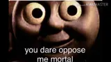 Darkened close-up of a Thomas the Tank Engine face with bulging eyes, captioned "you dare oppose me mortal", KineMaster watermark