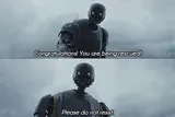 Two-panel still of a tall black droid against a grey sky, subtitled 'Congratulations! You are being rescued! Please do not resist.'