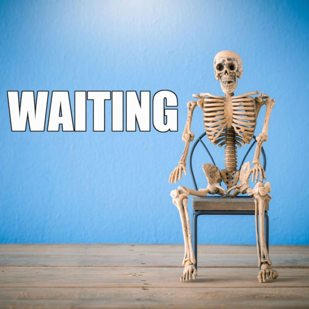 A skeleton slumped waiting on a bench